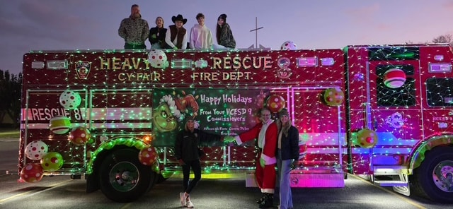 Holiday decorated fire truck with group